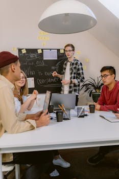 Young diverse team brainstorming ideas around a table in a modern office environment.