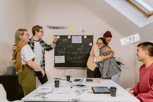 A diverse group of young professionals celebrating a successful project in a modern office setting.