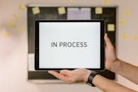 Hands of a Person Holding a Tablet