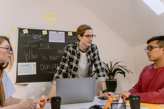 Young professionals engaged in collaborative brainstorming session at modern office space.