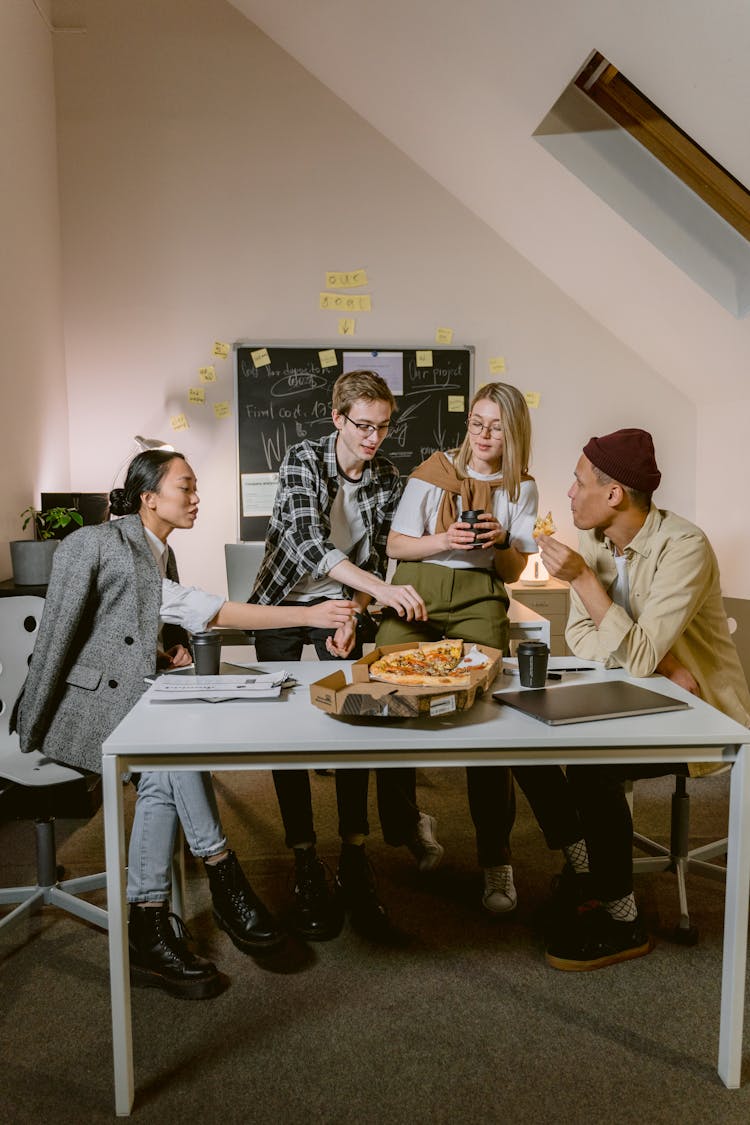 People At The Table Eating In An Office