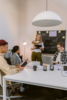 Group of professionals engaging in a team meeting in a contemporary office space.