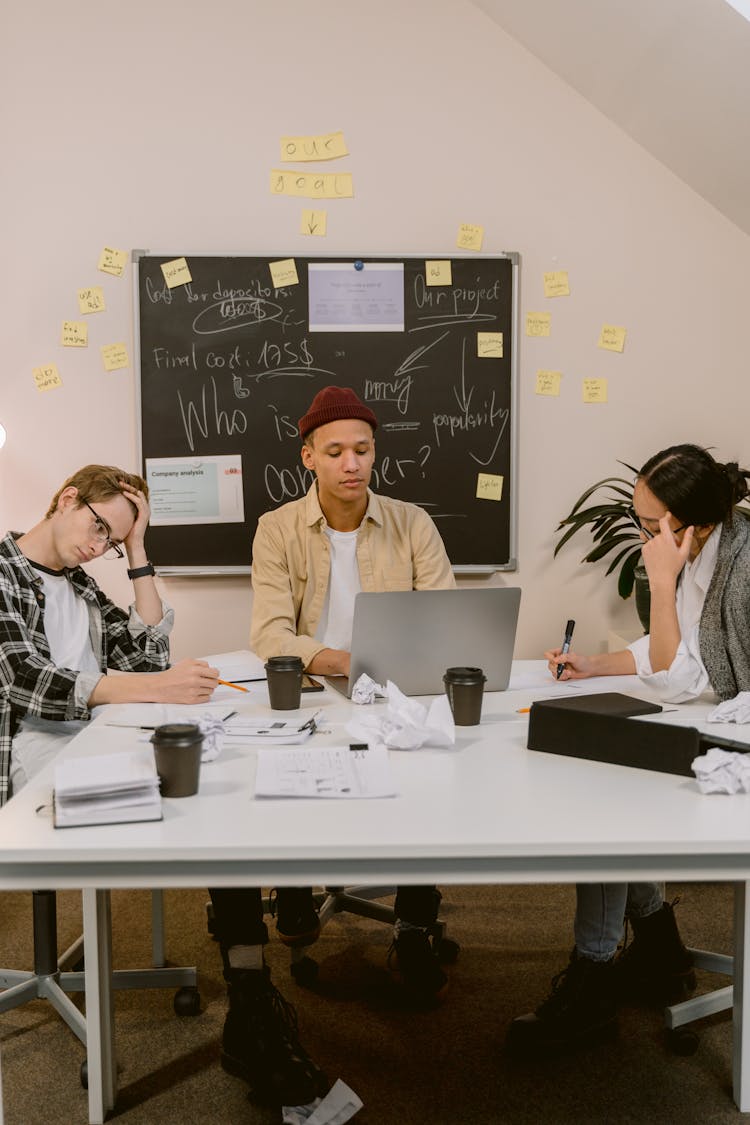 A Group Of People Planning While Sitting Near The Table