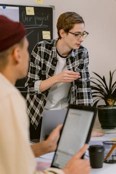 Group of young professionals in a focused discussion at modern office.