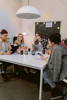 Young professionals engaged in a creative brainstorming session at a modern office.