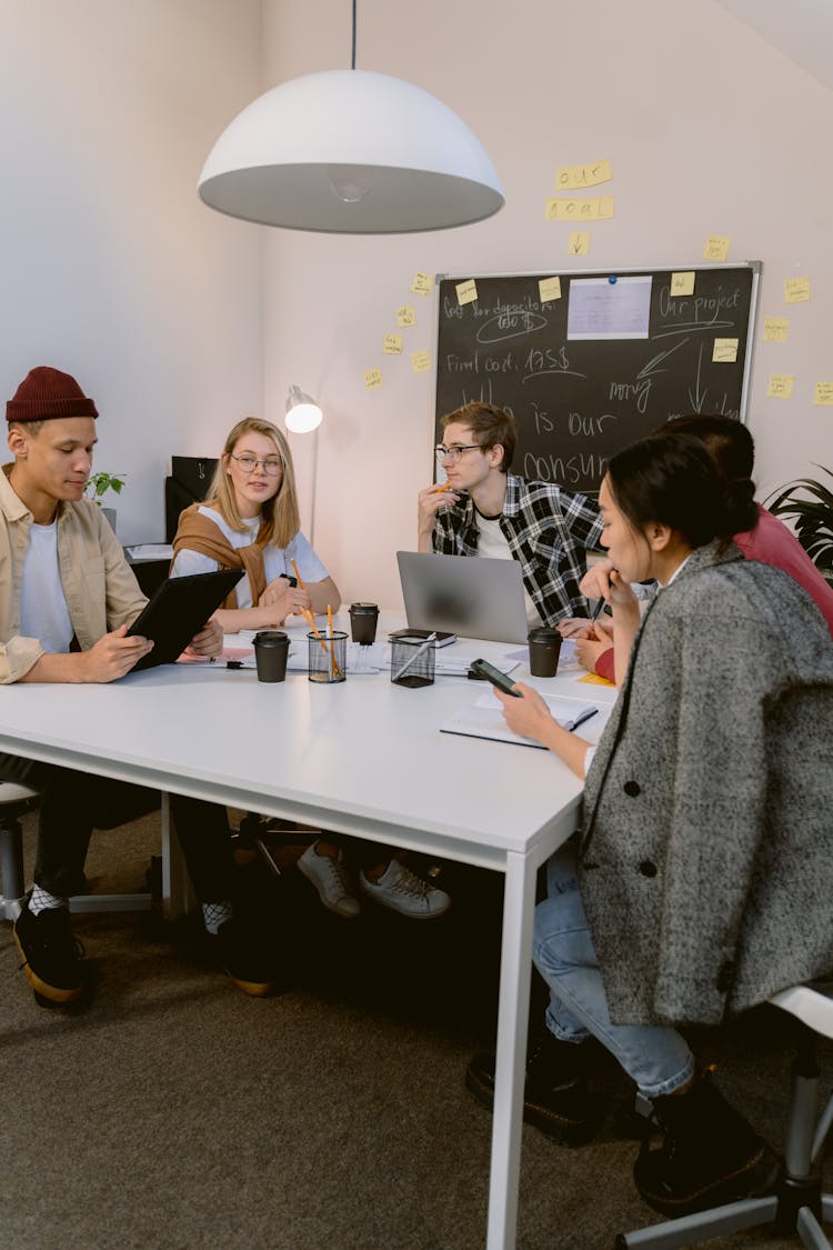 A Group Of People Sitting While Having Conversation