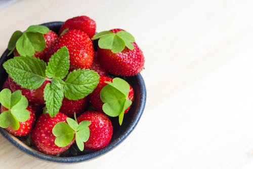 Close-Up Photo of Red Strawberries in a Black Bowl
