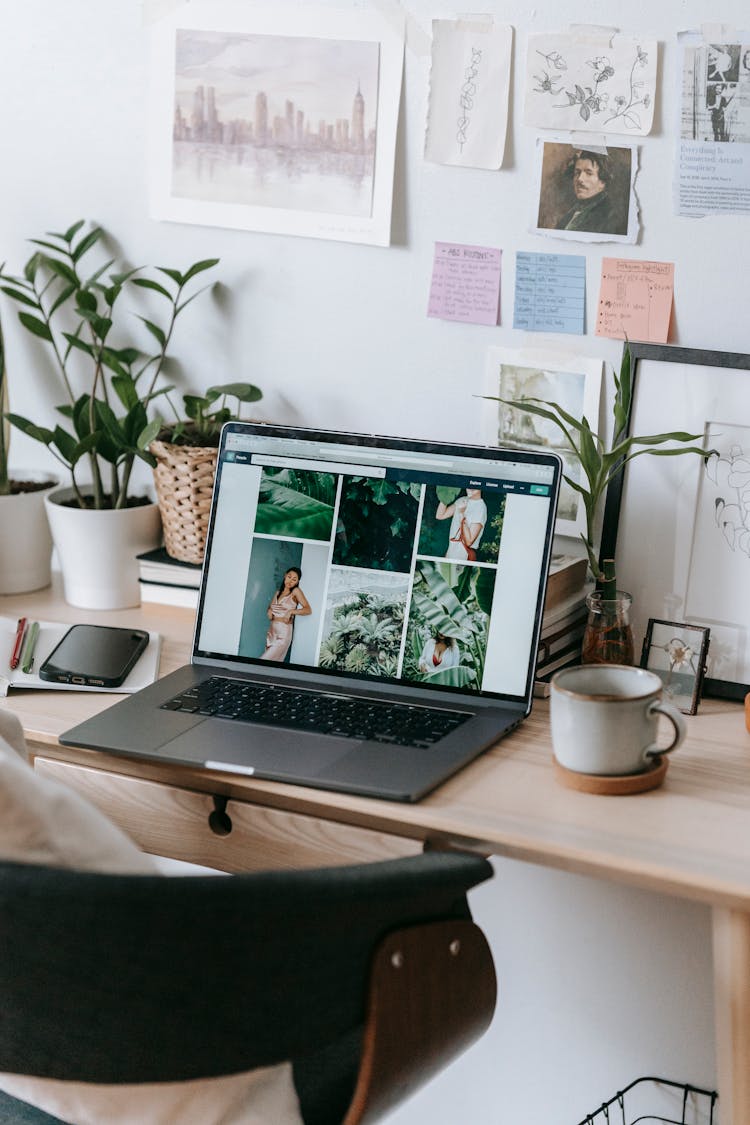 Laptop With Many Different Photos At Table