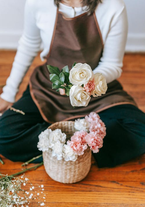 Free Crop woman arranging bouquet of flowers Stock Photo