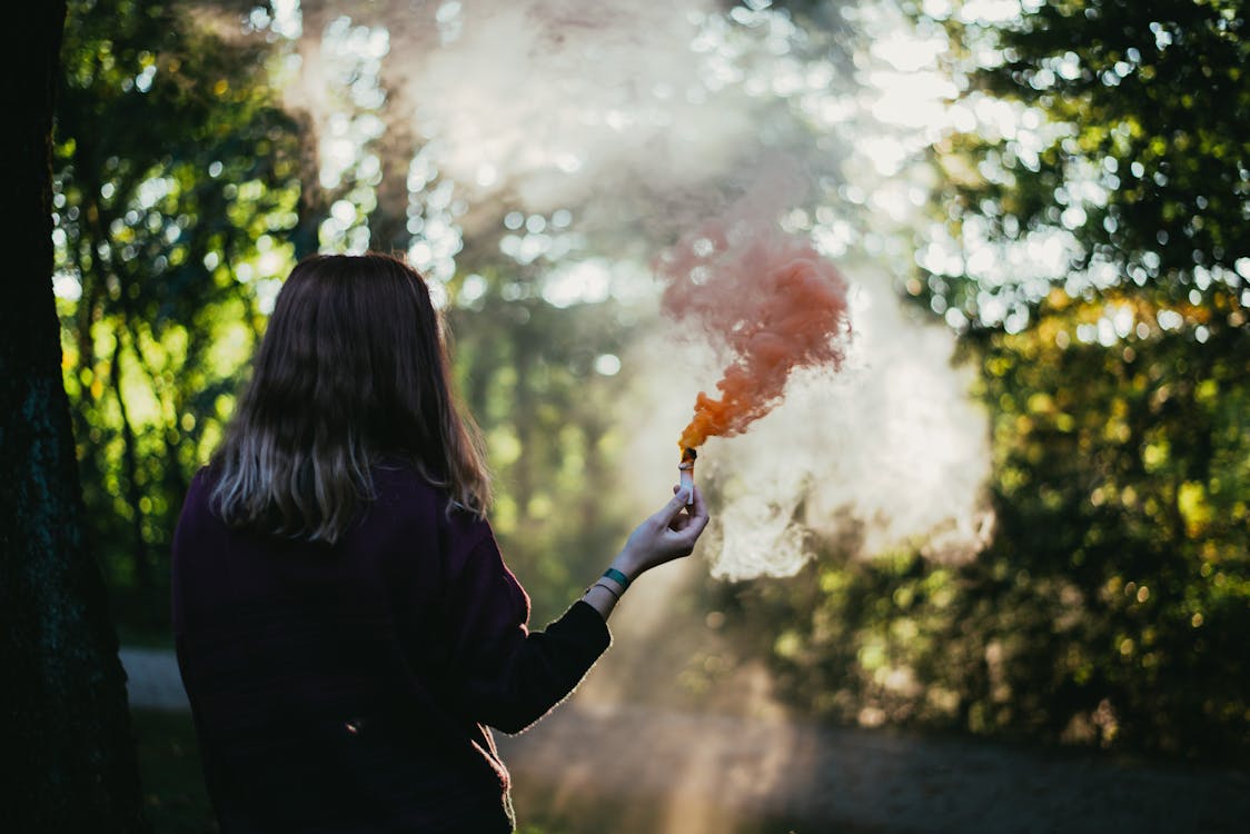 Free Woman Holding Red Flare Stock Photo