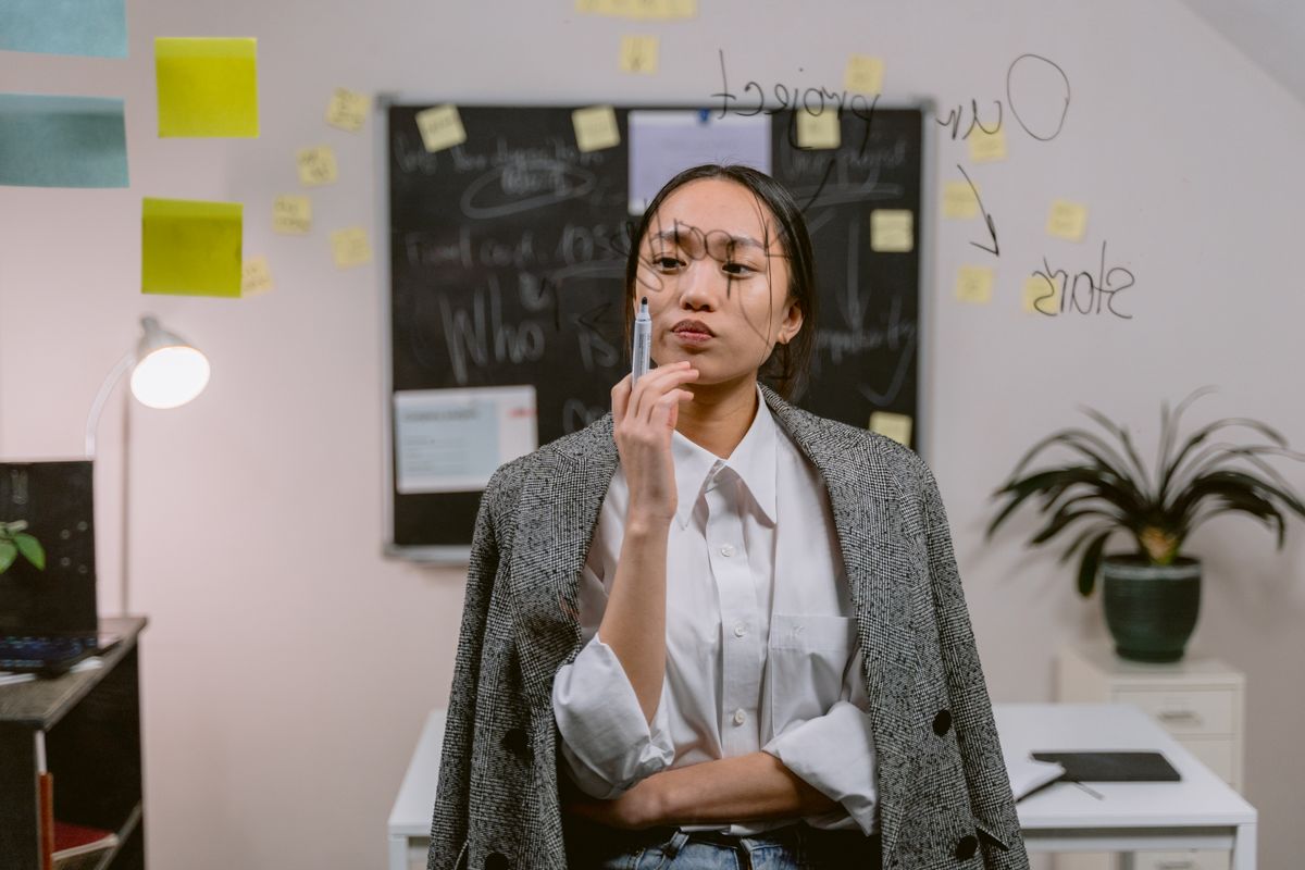A professional reflecting thoughtfully in an office
