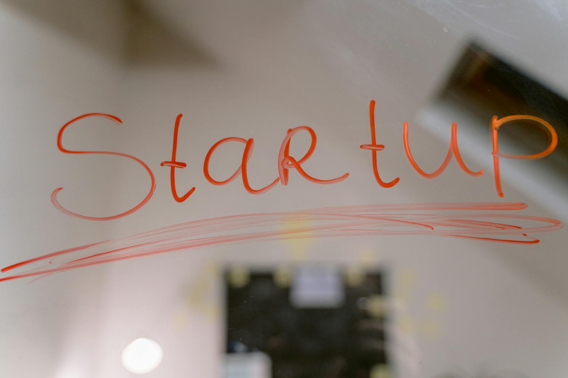 Conceptual image of startup text written on a mirror, symbolizing innovation and new beginnings.