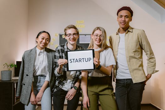 A diverse group of smiling young professionals showcasing teamwork in a startup environment.