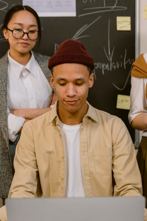 Free Teamwork-focused group of young adults working together in an office environment. Stock Photo