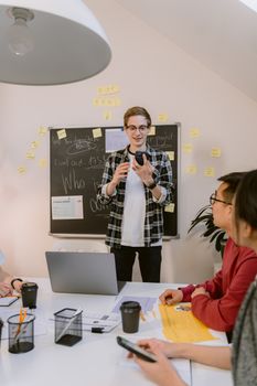Young professionals engaged in an interactive office meeting with diverse team members.