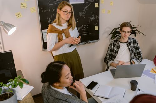 Free A group of young adults engaging in a collaborative office meeting with a focus on creativity and teamwork. Stock Photo