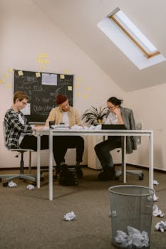 Young professionals engage in a brainstorming session in a modern office setting, showcasing teamwork and creativity.