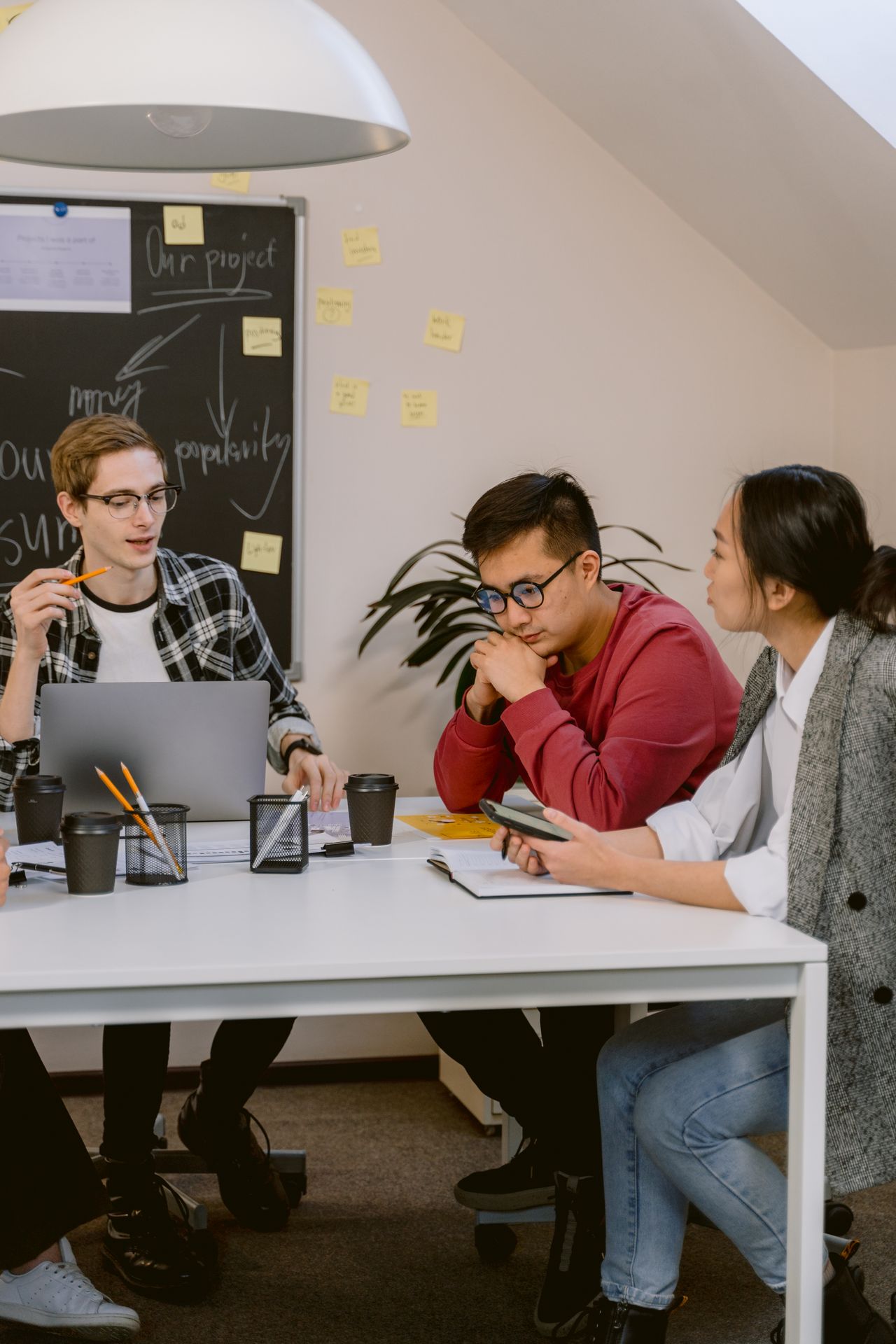 A diverse group of young professionals brainstorming in a modern office setting