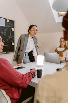 Young professionals discussing strategy in a dynamic office setting with collaborative teamwork.