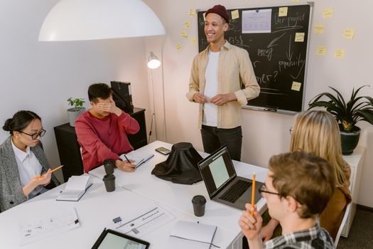 Diverse team collaborating in a modern office setting, brainstorming and working together.