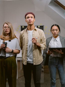 A diverse group of young adults brainstorming ideas in a contemporary office setting.