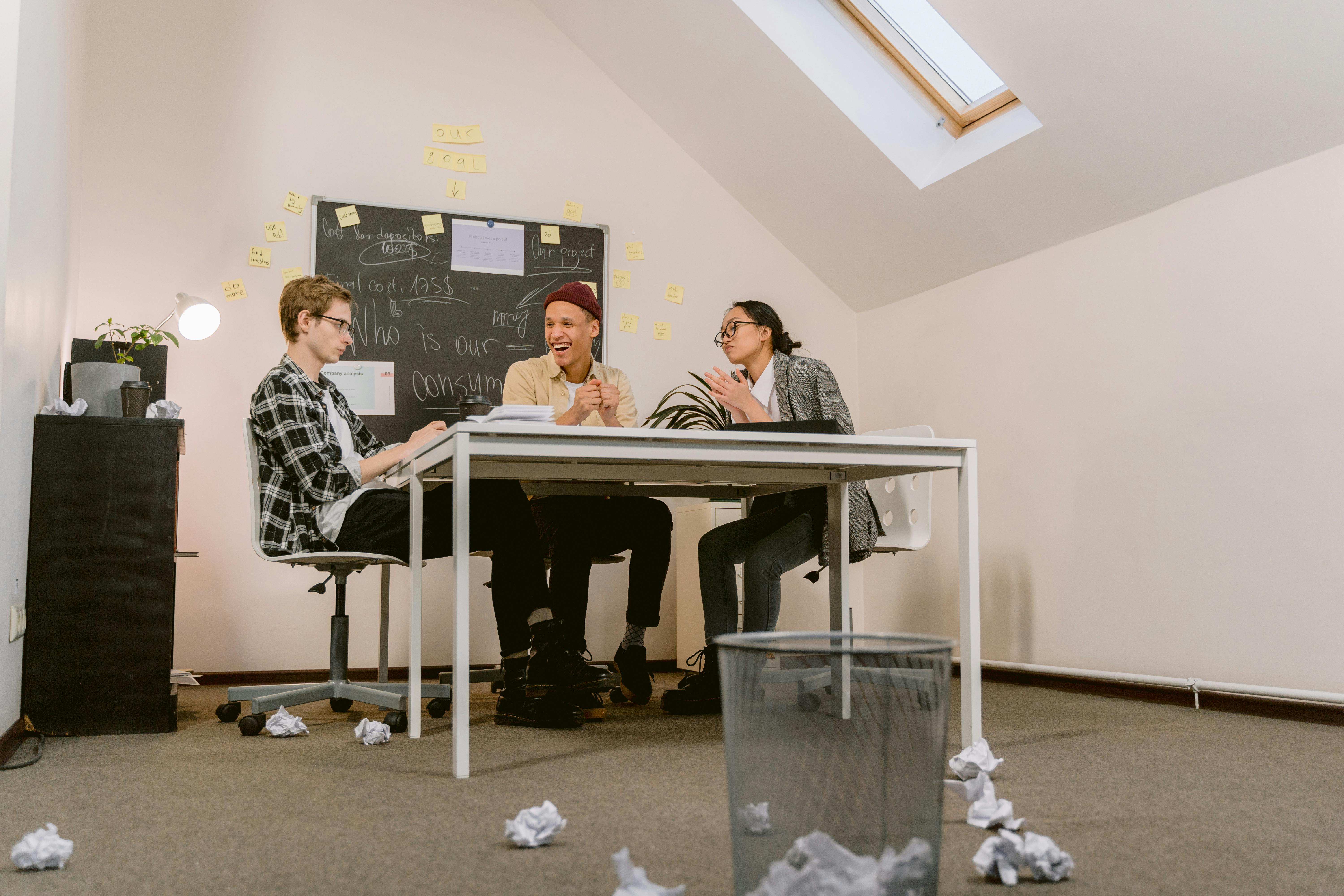 A team collaborating around a table during a planning session - IT disaster recovery Grand Rapids