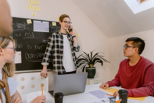 Man Talking on the Phone While in a Meeting