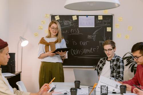 Free A diverse team collaborates on consumer insights in a modern office setting, showcasing teamwork and innovation. Stock Photo