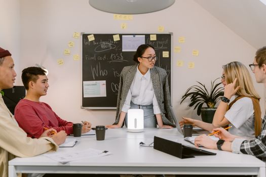 A group of professionals collaborating during a meeting in a modern office setting.