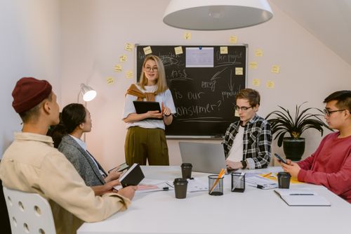 Free A diverse group of professionals engaged in a collaborative meeting in an office environment. Stock Photo