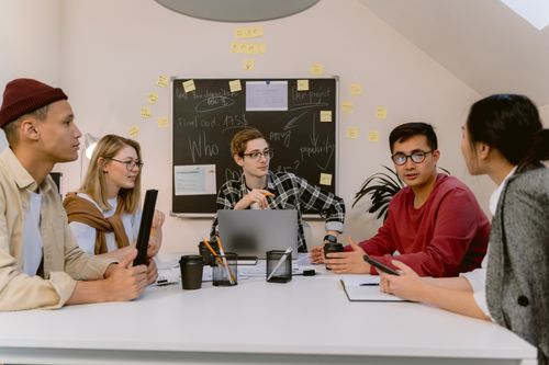Free Diverse group of professionals brainstorming in a modern office setting for a creative project. Stock Photo