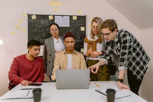 People Looking at the Screen if a Laptop Together