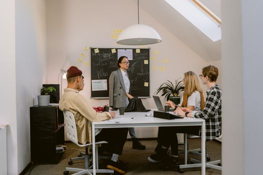 Team members engaged in a creative brainstorming session in a modern office setting.