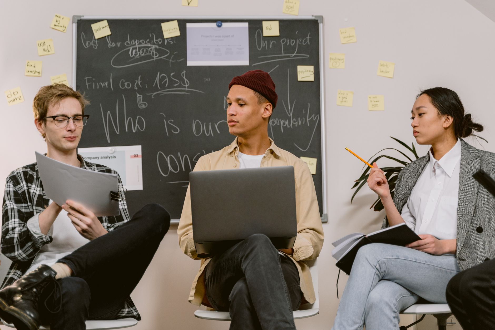 Team of software developers reviewing code on computer screens