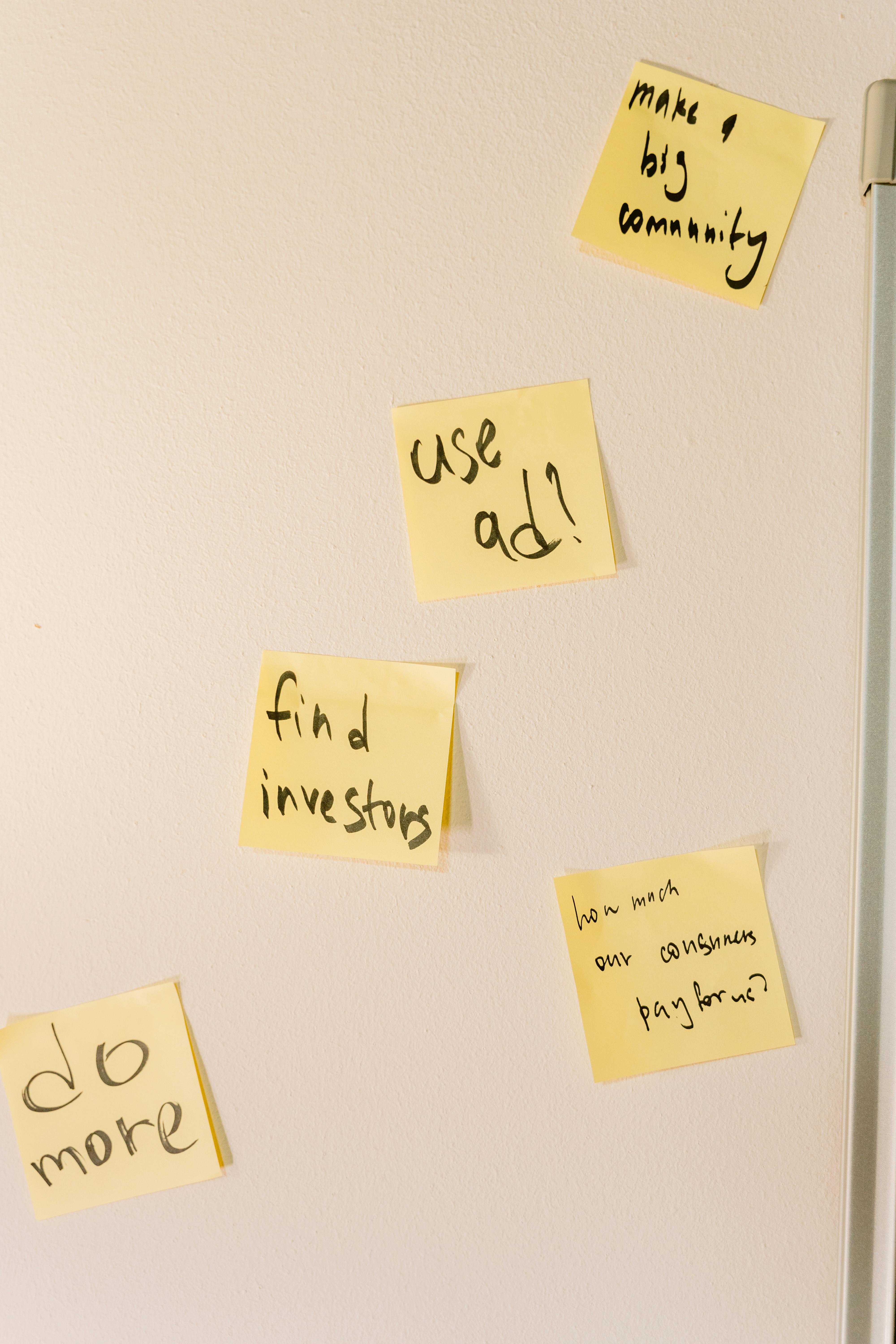 Team members using colorful notes on a wall to build an empathy map together.