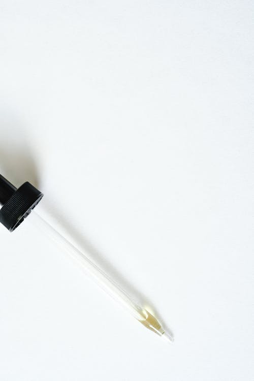 Free Close-Up Shot of a Pipette on a White Surface Stock Photo