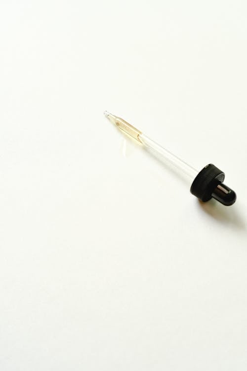 Close-up of a Pipette Lying on White Background