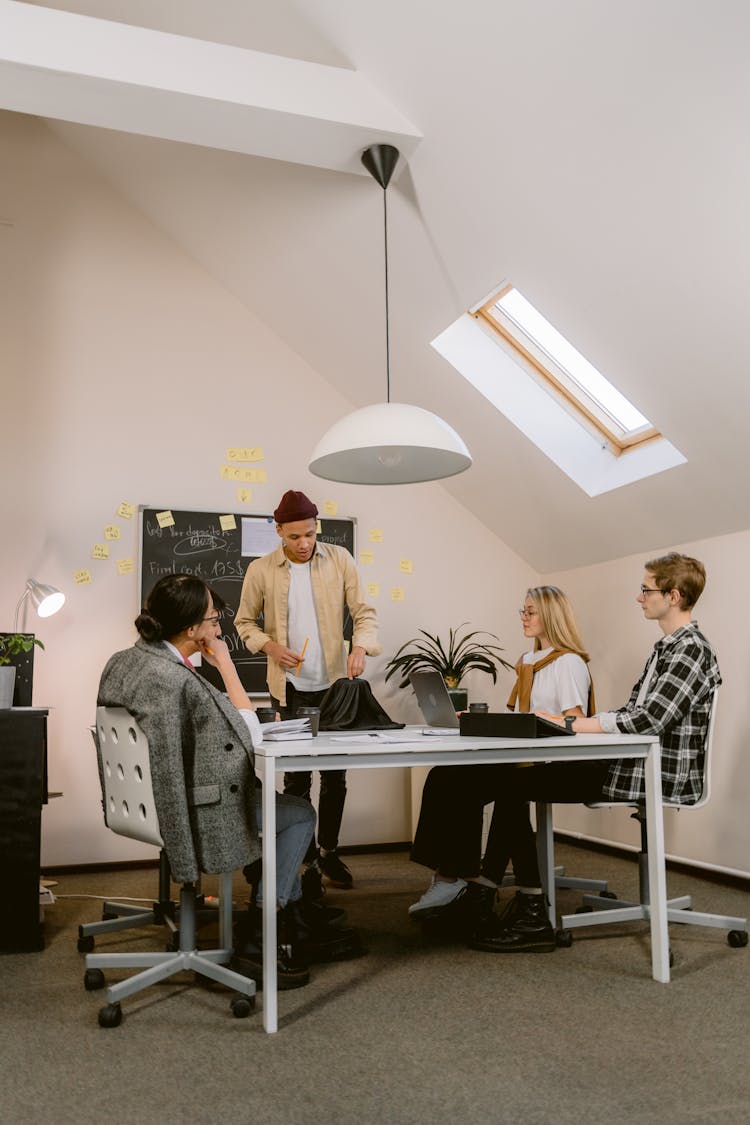 Man Wearing Beanie Presenting At The Office