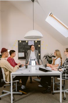 A diverse group of colleagues in a brainstorming session in a modern office setting.