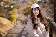 Woman with Long Hair Wearing White Cap