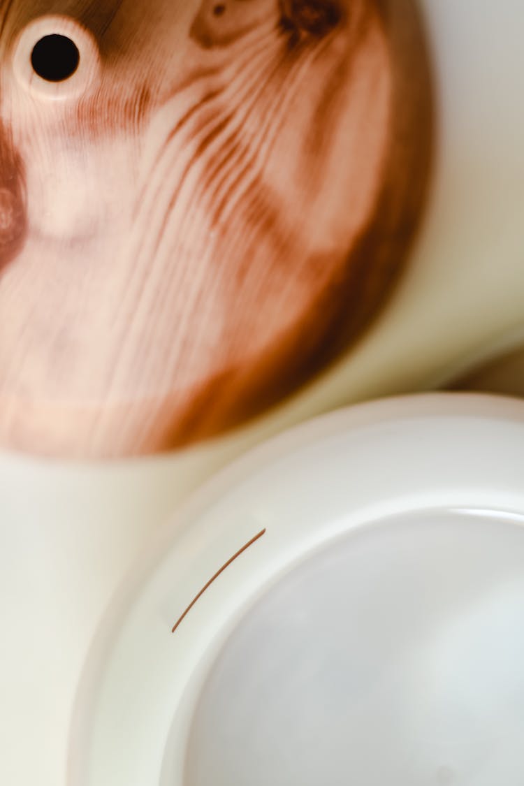 Flatlay Shot Of Wooden Diffuser And White Plastic Bowl