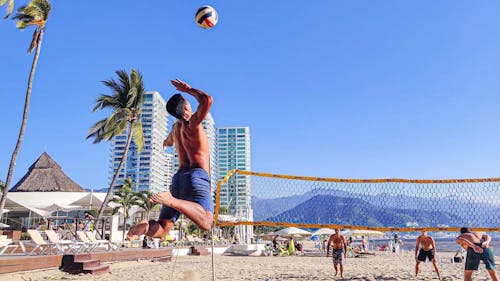 A Man Playing Volleyball at the Beach