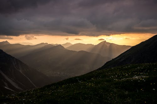 A Green Grass on Mountain Under the Dark Clouds