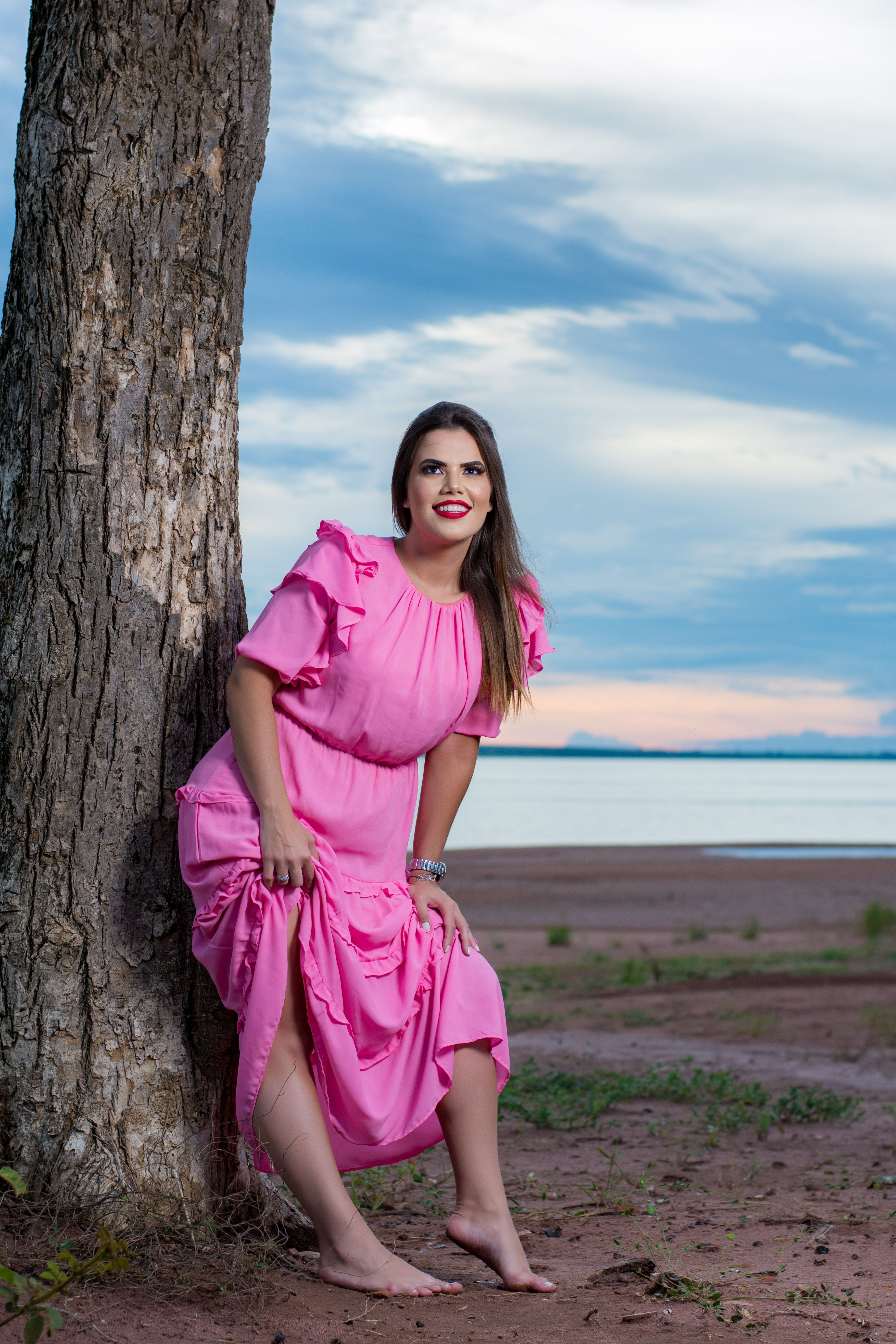 Woman in Pink Dress Standing Beside a Tree · Free Stock Photo