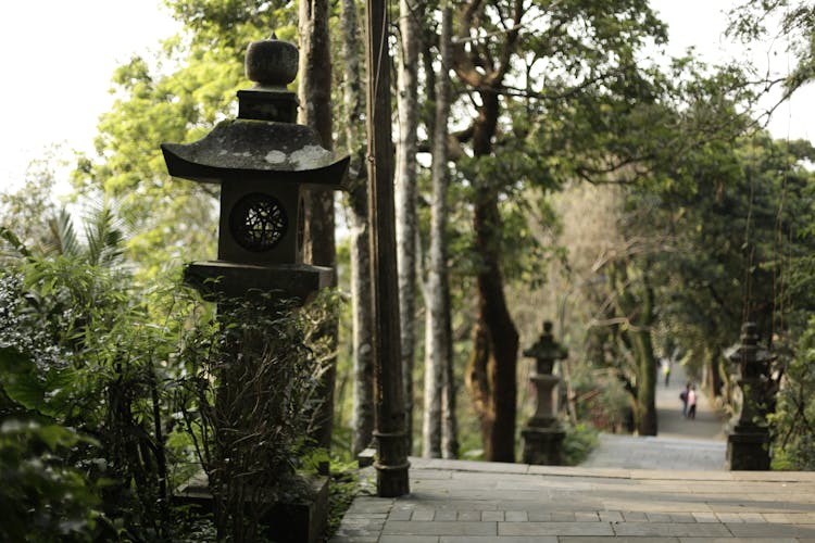 Black Concrete Lamp Posts On Walkway