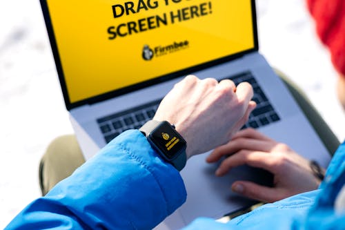 Person Wearing Blue Long Sleeve Shirt and Black Smartwatch