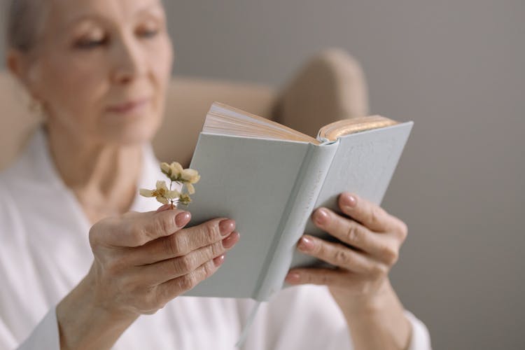 An Elderly Woman Reading A Book