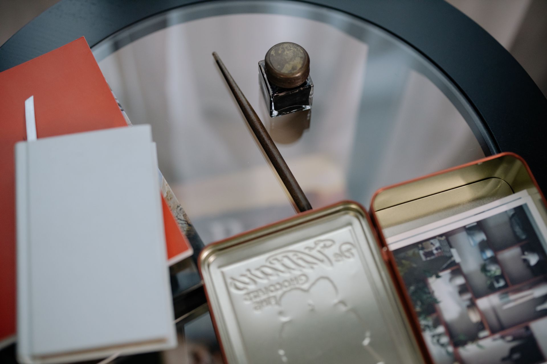 Box with Photos and Journals Lying on a Glass Table