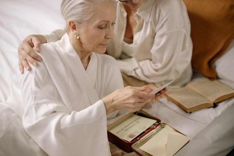 Gray Haired Woman Looking At The Old Photos