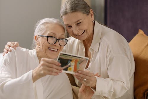 Free Elderly Women Happily Looking at the Photo Stock Photo